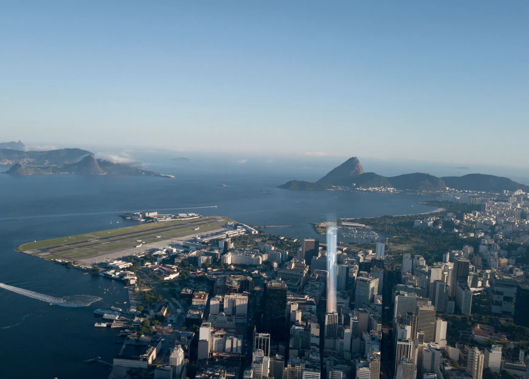 Vista aérea do quadrilátero do Centro do Rio onde fica o Q Studios, com o Aeroporto Santos Dumont e a Enseada de Botafogo ao fundo