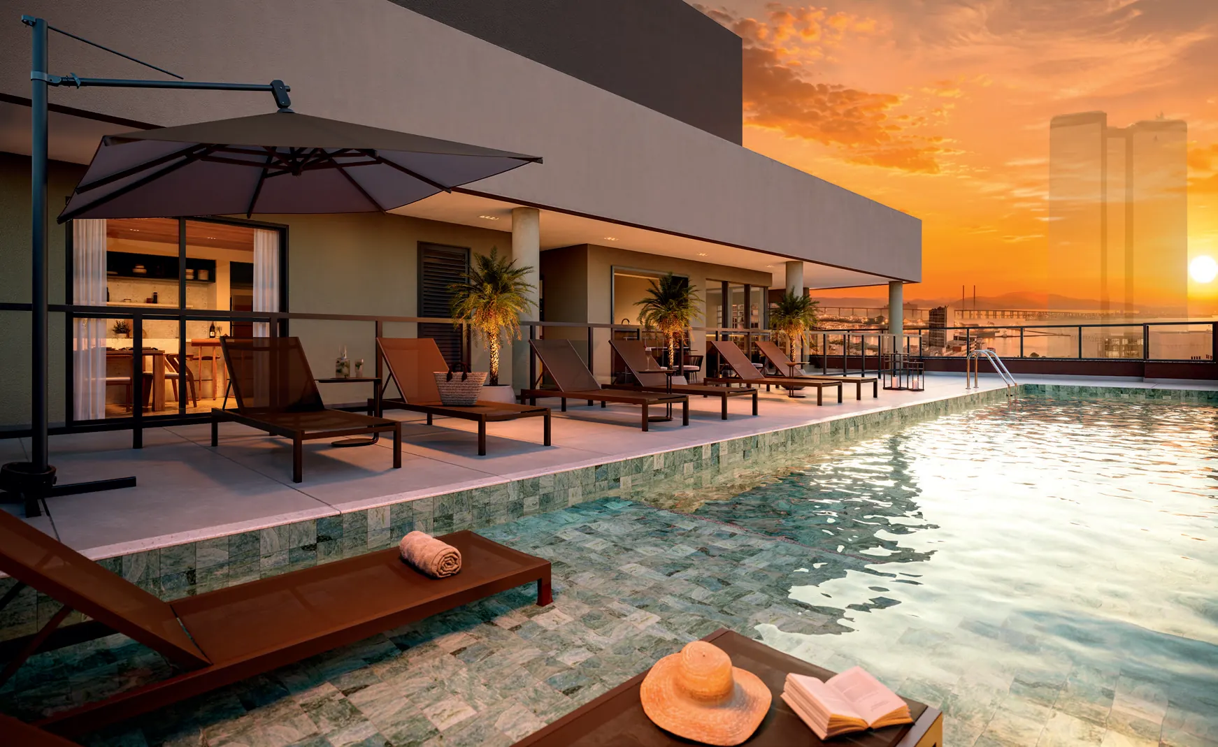 Piscina com deck molhado, no rooftop do Q Studios, com espreguiçadeiras e vista do Centro do Rio ao pôr do sol