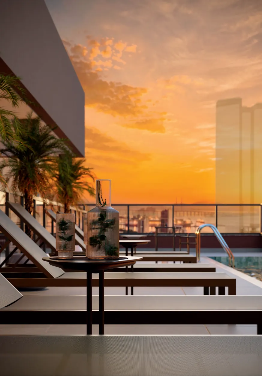 Varanda de studio do Q Studios ao pôr do sol, com vista para a Baía de Guanabara
