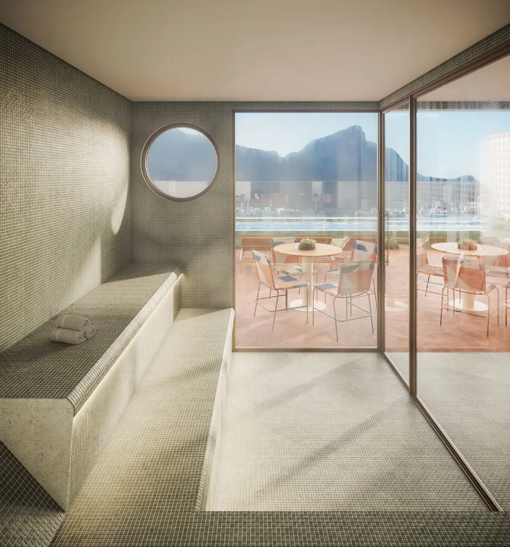 Sauna do Parque Studios com janela redonda e vista para o Morro Dois Irmãos